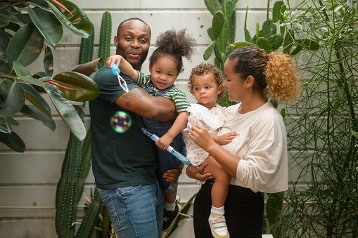 Portrait of Happy African American family enjoying gardening at home