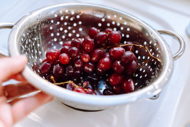 istock bunch ripe red grapes washed in colander in kitchen 1796601272