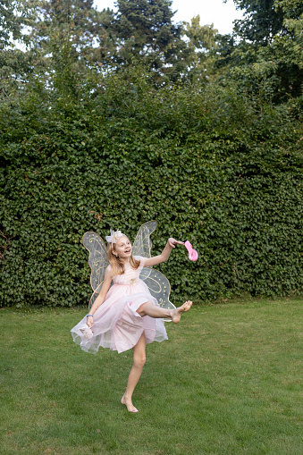 portrait of a happy little girl in fairy costume outdoor. High quality photo