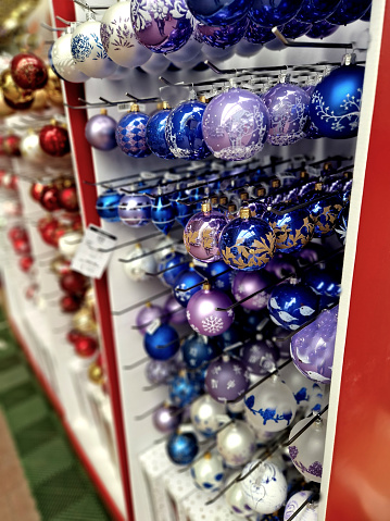 glassworks produce shiny scanned ornaments blown from glass by master glassblowers. fun and colored with cartoon motifs with glitter. children love swinging shelf in store, marketing, advertisement, festive