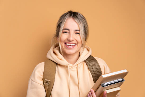 istock happy student holding academy book and smiling 1796619466