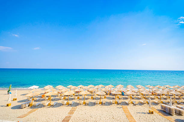 istock Panoramic top view of straw umbrella on an empty beach 179662334