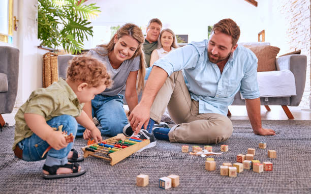 istock Parents, learning and child playing with toys for education and development at home. Motor skills, childhood education and little boy playing with abacus with mother and father for bonding and care 1796631414