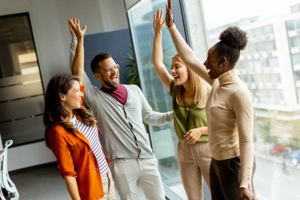 istock Young multiethnic startup team hold hands together in the modern office 1796631969