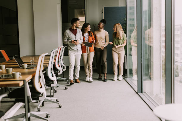 istock Young multiethnic startup team walking in the modern office 1796631975