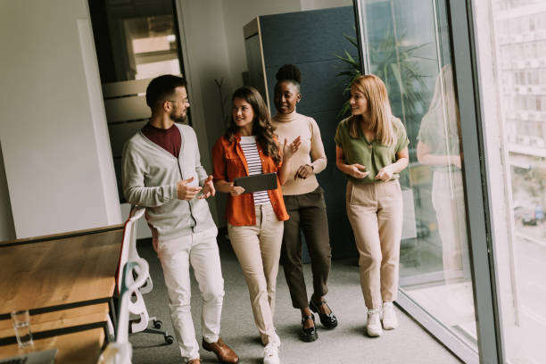 istock Young multiethnic startup team walking in the modern office 1796631984