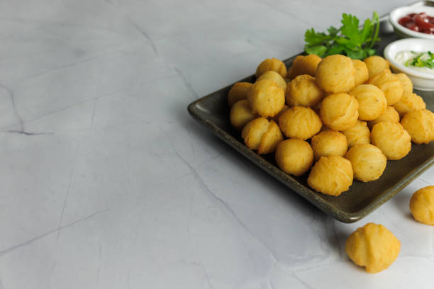 istock Duchess potatoes, homemade, typical in chile, with parsley, on a rectangular plate, container with, ketchup, mayo, on white background, close up, copy space. Typical Chilean food concept 1796647982