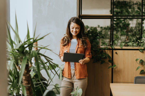 istock Young woman standing with digital tablet at the office 1796648569