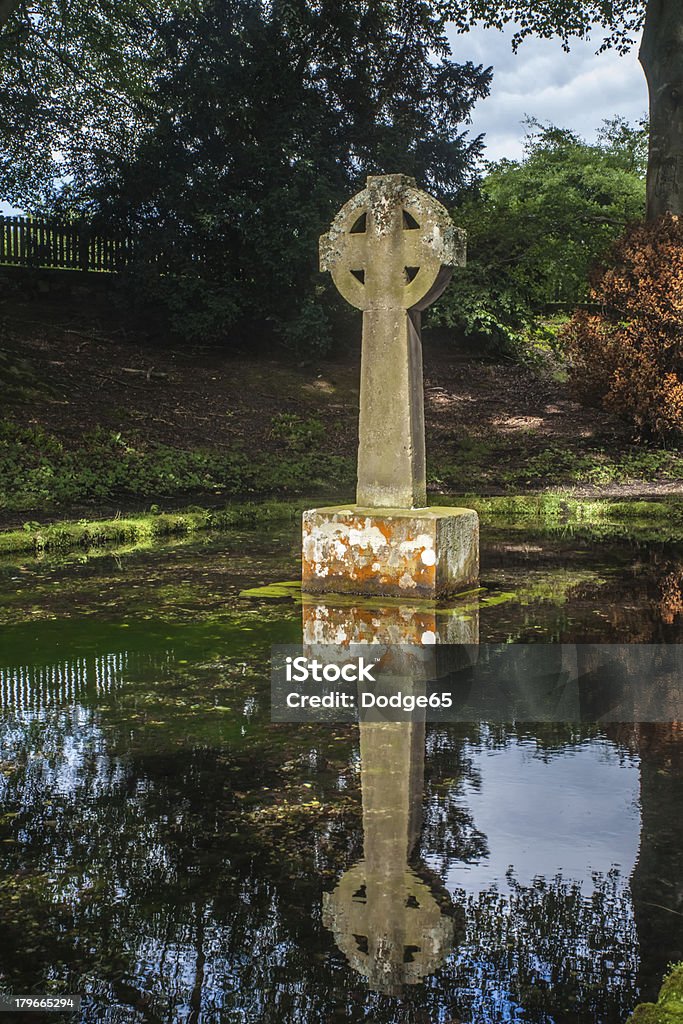Celtic Cross Reflection Celtic Cross Reflection In an Ancient  Baptism spring Celtic Style Stock Photo
