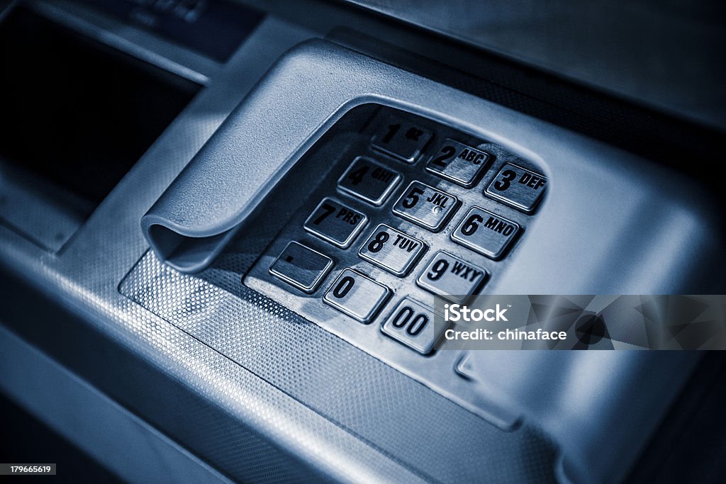 keypad of atm metallic keypad of an automated teller machine., blue toned image. adobe rgb 1998 use........... ATM Stock Photo