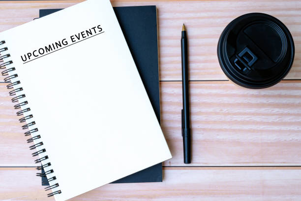 istock Upcoming events text on notepad with pen and disposable coffee cup a desk 1796659141
