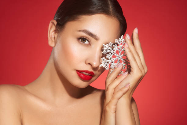 istock Beautiful young woman with glowing snowflake 1796662978