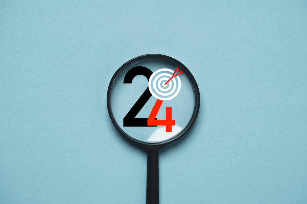 istock 2024 year with dartboard inside of magnifier glass for focusing in objective target include business , life , health , family concept. 1796666208