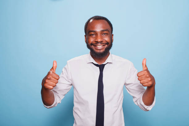 istock Smiling man giving thumbs up to camera 1796667291