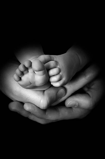 istock baby feet on hands 179666811