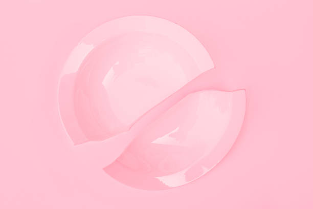 istock Pink broken plate on a pink background, top view. Ruined happiness concept 1796672183