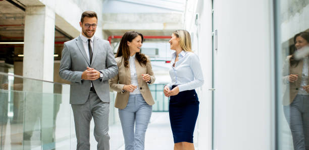istock Young startup team have a discussion while walking in the modern office corridor 1796695583
