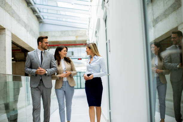 istock Young startup team have a discussion while walking in the modern office corridor 1796695592