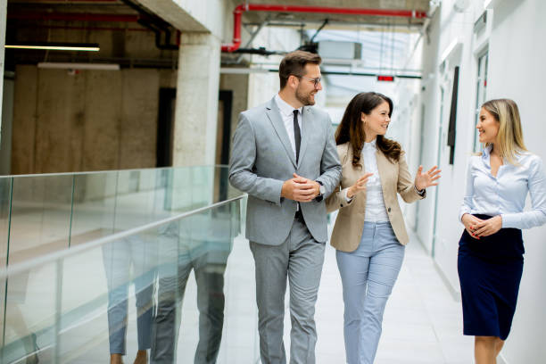 istock Young startup team have a discussion while walking in the modern office corridor 1796695595