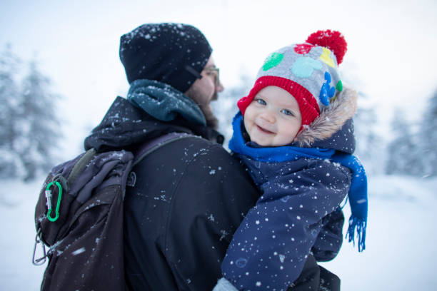 istock Cute baby boy enjoying on the snow. 1796704245