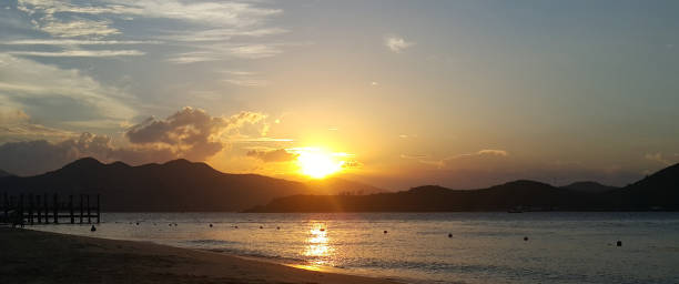 istock Beautiful sunset or sunrise over sea and mountains 1796708944