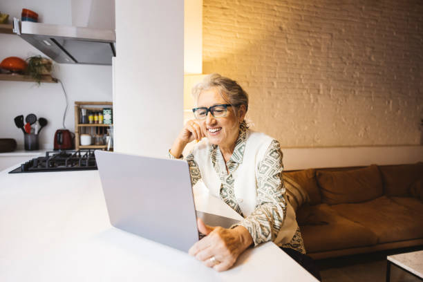 istock Senior woman using laptop at home 1796726719