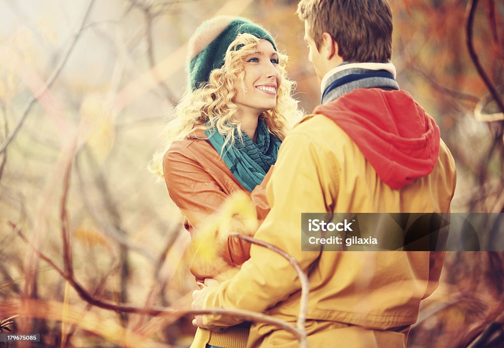 Fall romance. Young happy couple enjoying autumn day in a park. 20-24 Years Stock Photo