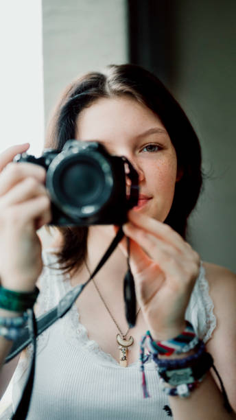 istock Transgender non-binary teenager with a camera, hobby photographer 1796751824