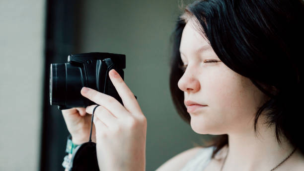 istock Transgender non-binary teenager with a camera, hobby photographer 1796751828