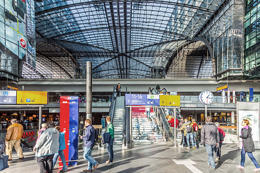 Berlin, Germany - May 16, 2014: Wide-angle view of the Central railroad station in Berlin with people waiting and shopping.