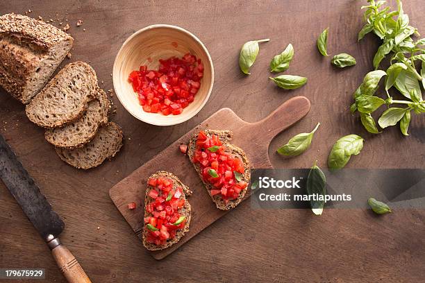 Bruschetta On Wooden Table Stock Photo - Download Image Now - Antipasto, Appetizer, Basil