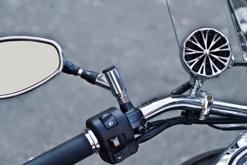 Steering wheel and rearview mirror of the motorbike - view from the driver's place
