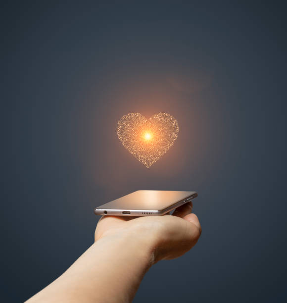 istock Circuit board heart symbol on hand holding smartphone 1796770229