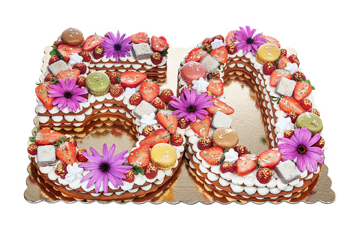 Anniversary cake in the shape of the number 50 years with puff pastry with marshmallows, strawberries and flowers.