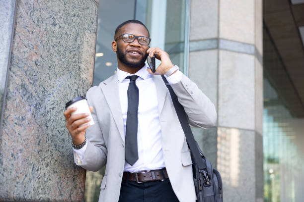 istock Black Businessman Having A Call During The Coffee Break. Modern Office Building 1796775913