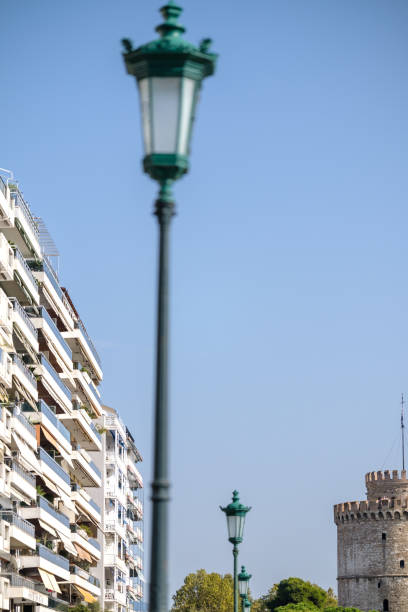 View of a lantern, residential buildings and the famous White Tower, also known as Lefkos Pyrgos in Thessaloniki Greece