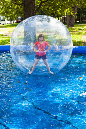 girl in water ball in open swimming pool