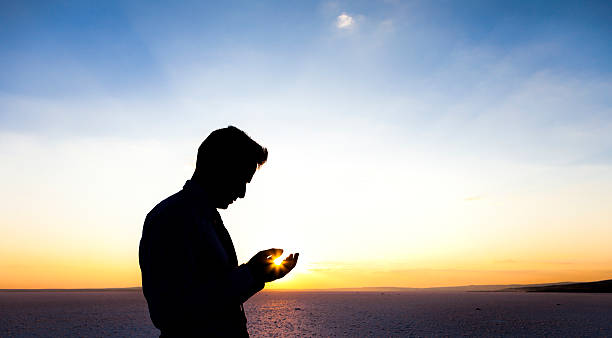 istock Silhouette of a praying man 179680065