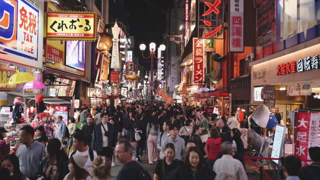 Large group Crowd of people enjoy central business shopping night street Dotonbori osaka japan
