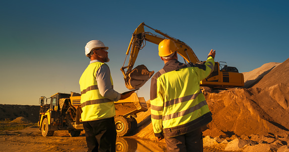Engineers checking project status at a construction site