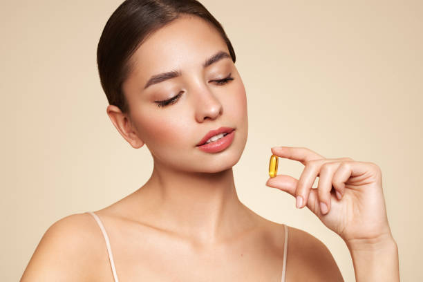 istock Beautiful Girl With Pill With Cod Liver Oil Omega-3 1796836445