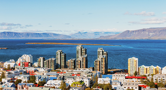 View of Reykjavik city during the day with colorful houses and mountains in the background