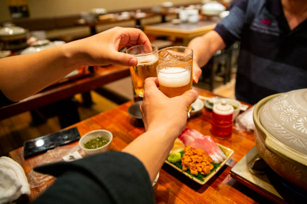 istock Three people toasting with mugs full of beer. 1796852179