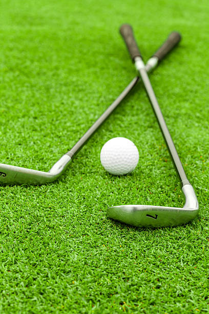 istock golf ball  tee in front of driver on green course 179685666