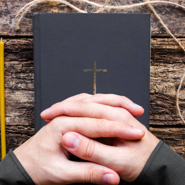 istock man praying on the bible 1796856803