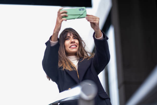 Enjoying playful windblown selfies outdoors.