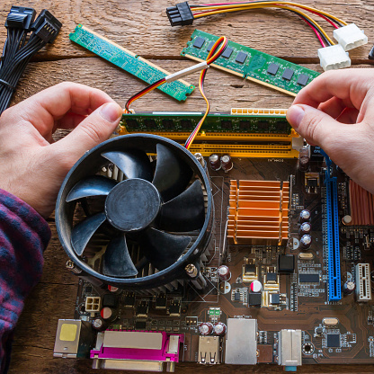 man repairing computer hardware