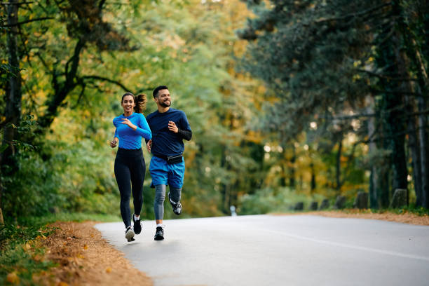 Young athletes running on the road in nature.