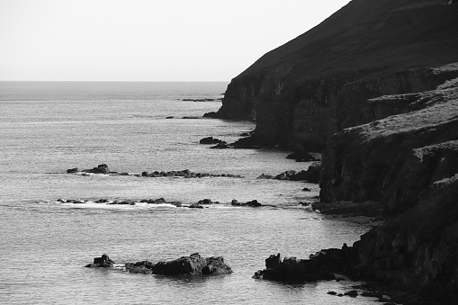 black and white image of coastline cliffs