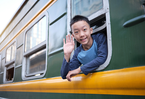 Portrait of boy sitting in the old train